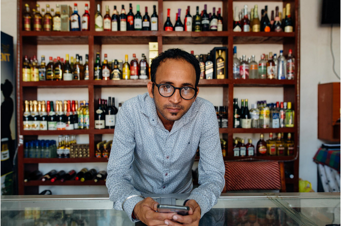 a liquor store stocked with different alcohol drinks]